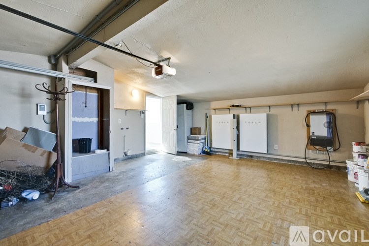 A room with a wooden floor and white walls is available for rent.