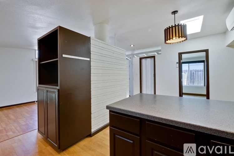 A kitchen with a brown refrigerator and a countertop.