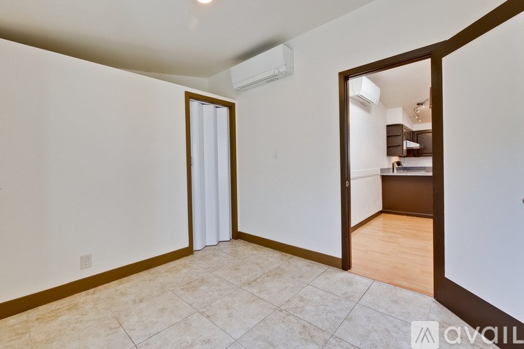 A room with a tiled floor and a sliding door leading to another room.