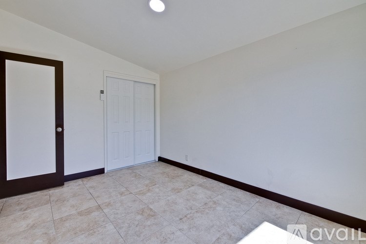 A room with a brown door and a white door.