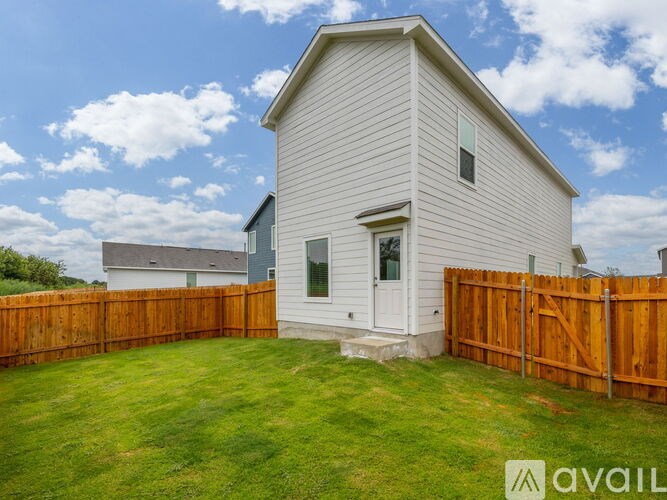 A house with a white exterior and a wooden fence.