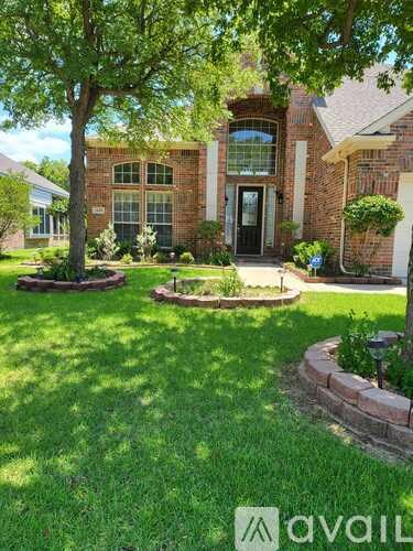 A house with a brick facade and a large front yard.