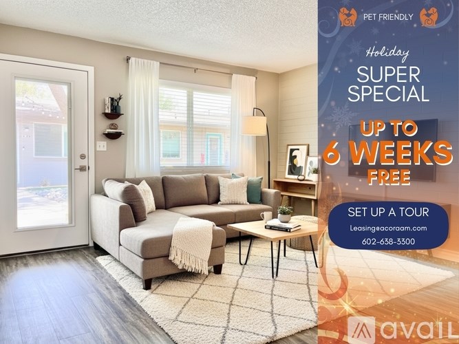 A living room with a sofa, a table, and a poster offering a free 6 weeks holiday special.