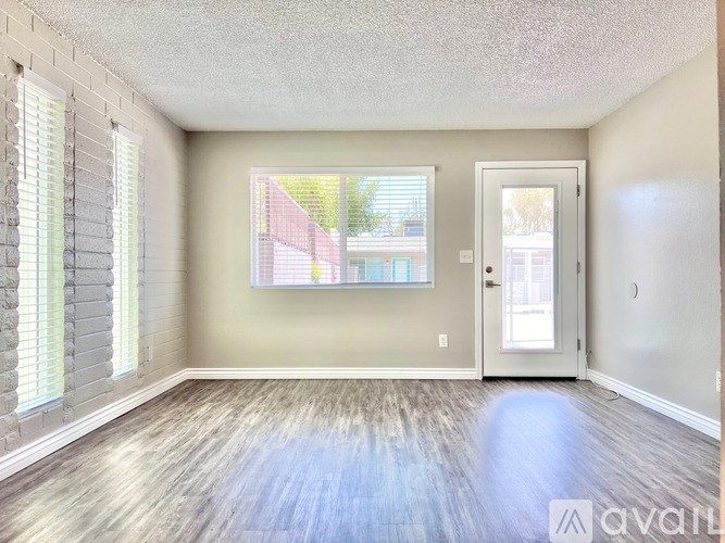 A room with a window and a door is available for rent.