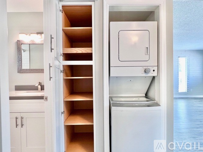 A white kitchen with a white fridge and a white door.