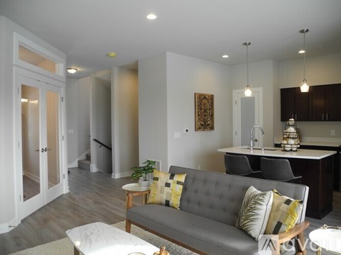 A living room with a grey couch and a coffee table.