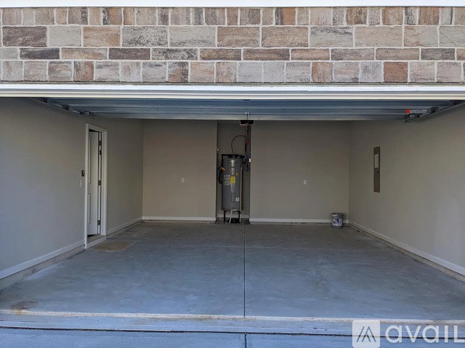 A room with a concrete floor and a brick wall above it.