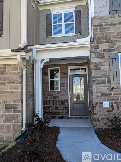 A room with a ceiling fan and carpeted floor.
