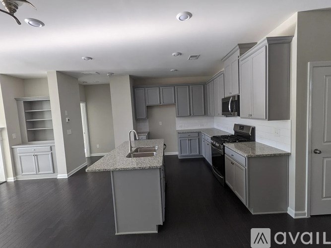 A kitchen with a granite countertop and stainless steel appliances.