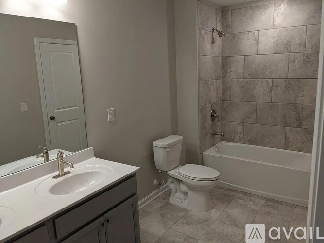 A bathroom with a toilet, sink, and bathtub.