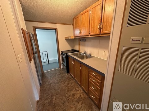 A kitchen with wooden cabinets and a sink.