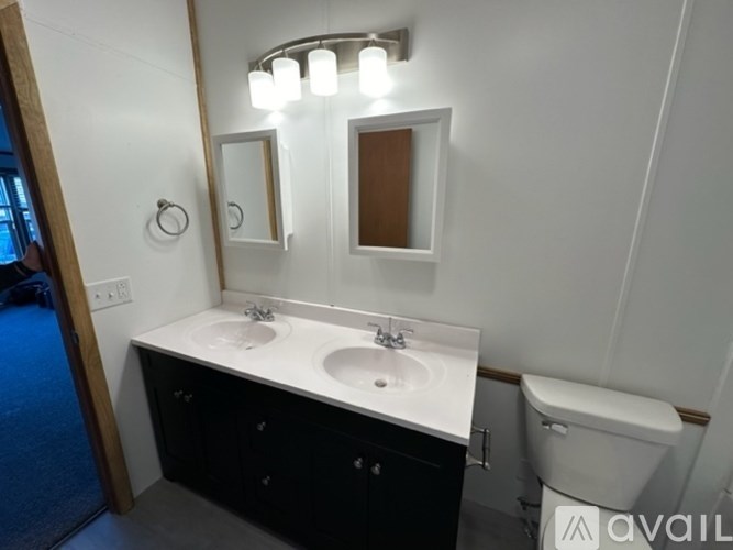 A bathroom with a white countertop and a toilet.