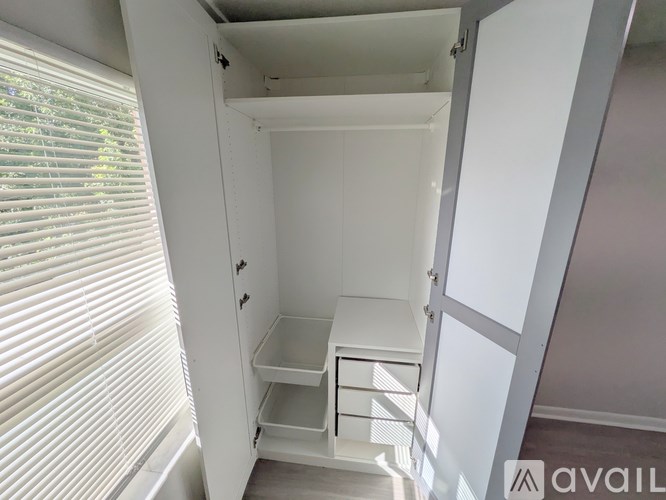A small white closet with a shelf and a drawer is shown.
