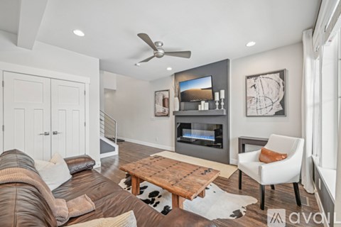 A living room with a brown leather couch and a wooden coffee table.