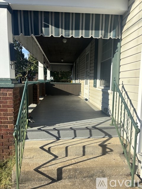 A wooden covered walkway between two buildings.