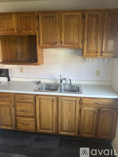 A kitchen with wooden cabinets and a white countertop.