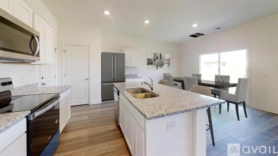A kitchen with a granite countertop and a sink.
