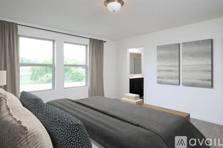 A bedroom with a large bed and a fireplace.