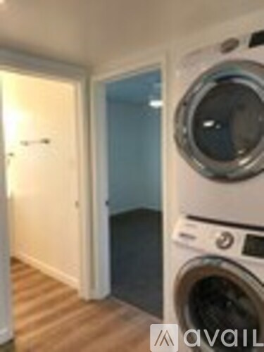 A washing machine is in a laundry room.