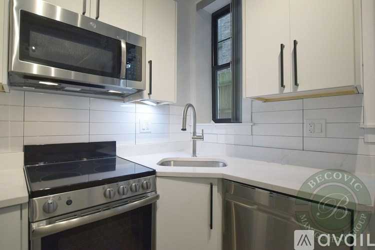 A modern kitchen with a stainless steel oven and microwave.