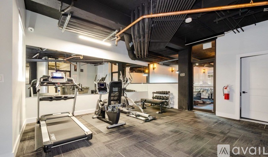 A gym with treadmills, weights, and exercise machines.