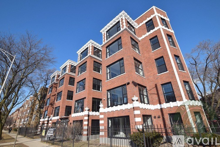 A tall red brick building with white trim and windows.