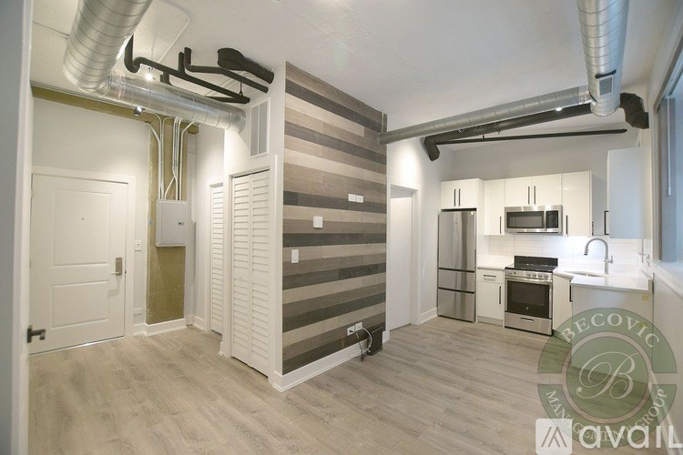 A kitchen area with a refrigerator, oven, and sink.