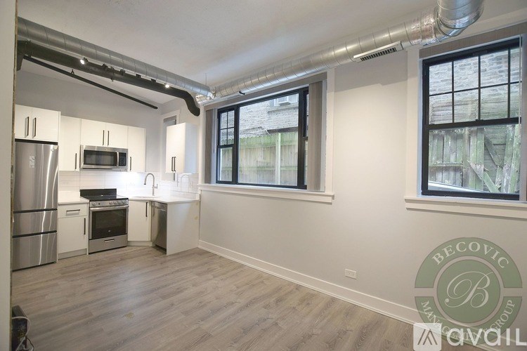 A kitchen with stainless steel appliances and a window.