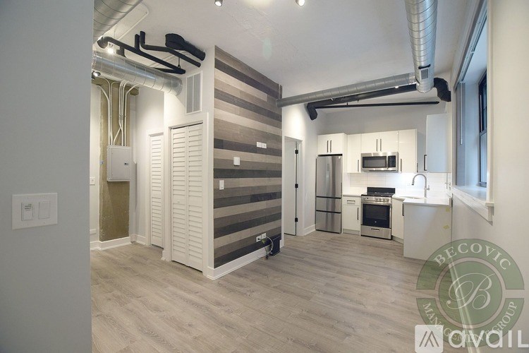 A modern kitchen with a refrigerator, oven, and microwave.