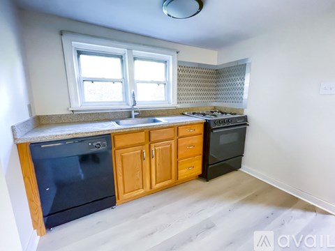 A kitchen with wooden cabinets and a black oven.