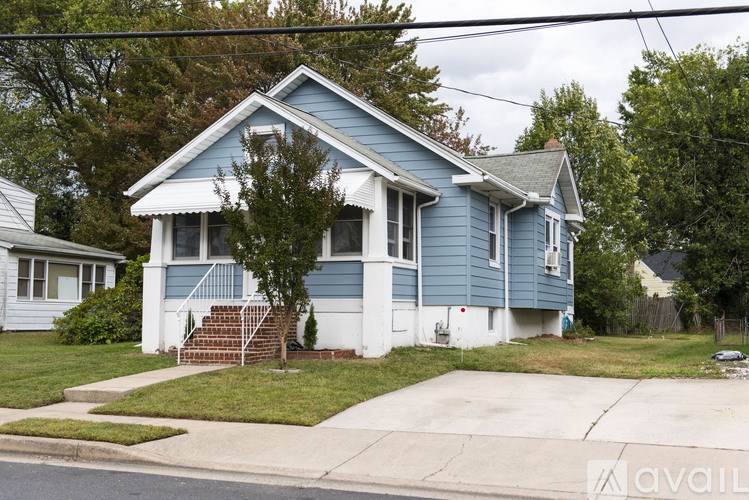 A blue house with a white door and windows.