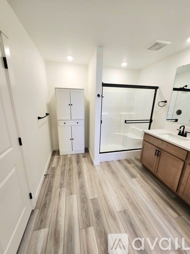 A small kitchen with a refrigerator, oven, and a window.