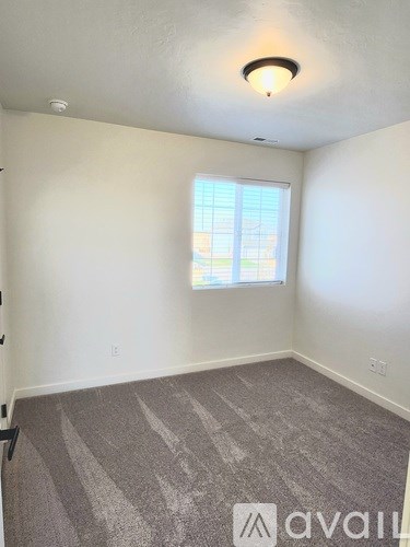 A bathroom with a sink, mirror, and wooden cabinets.