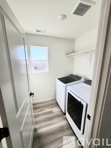 A park with a circular bench in the middle of a concrete path.