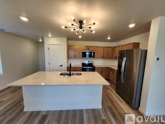 A kitchen with a granite countertop and stainless steel appliances.