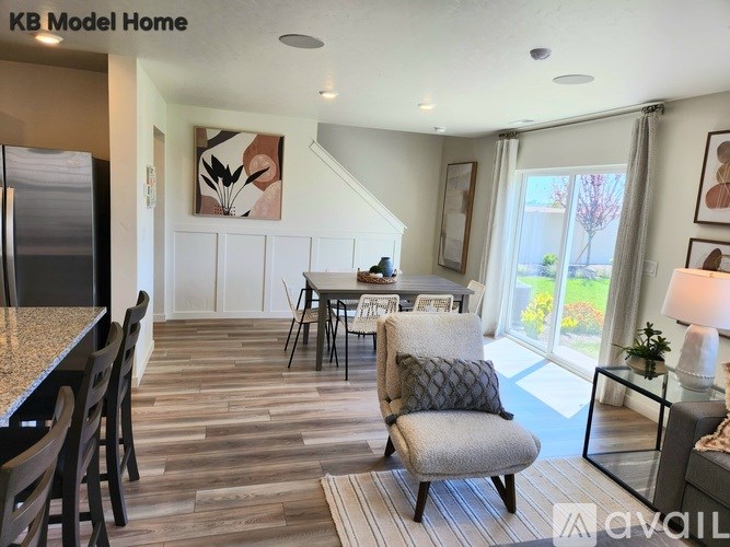 A room with wooden flooring and a window with blinds.