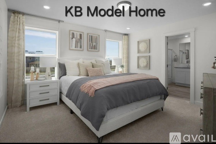 A bedroom with a large bed and a window with curtains.