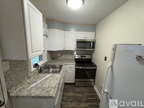 A kitchen with granite countertops and stainless steel appliances.