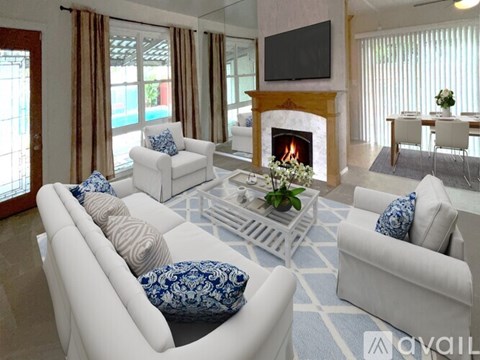 A living room with a fireplace and a television on the wall.