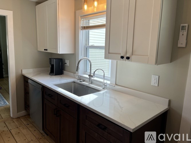 A kitchen with a sink and cabinets.