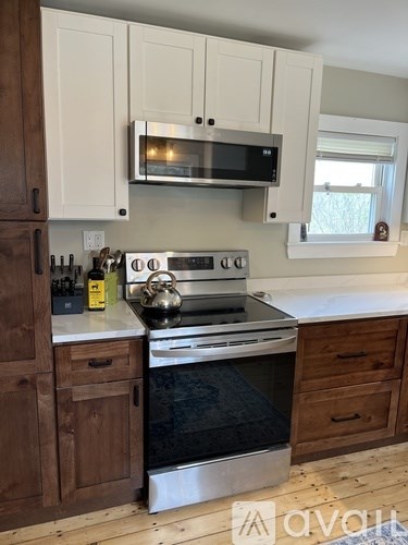 A kitchen with a stove top oven and microwave above it.