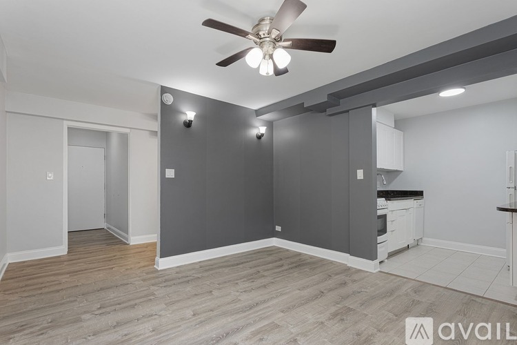 A room with a ceiling fan and light fixture.