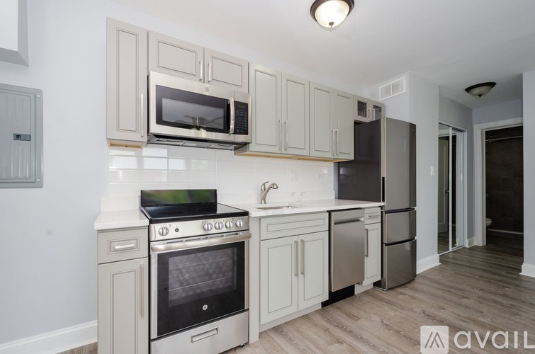 A kitchen with a stove, oven, microwave, and refrigerator.
