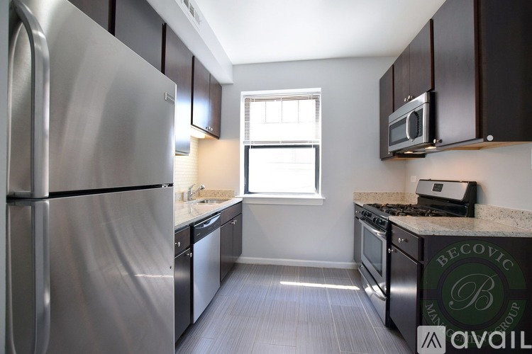 A modern kitchen with stainless steel appliances and a window.