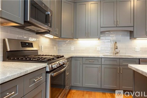 A kitchen with a stove top oven and microwave above it.