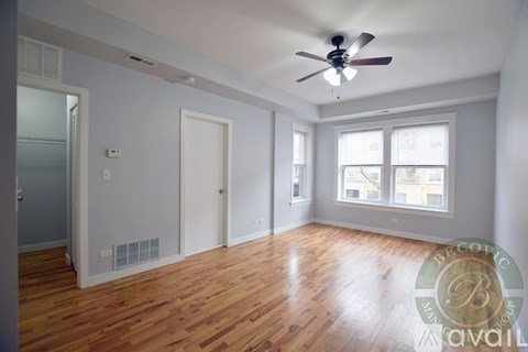 A room with wooden floors and a ceiling fan.