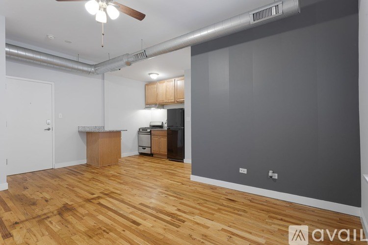 A room with wooden floors and a ceiling fan.