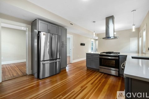 A kitchen with a stainless steel refrigerator and oven.