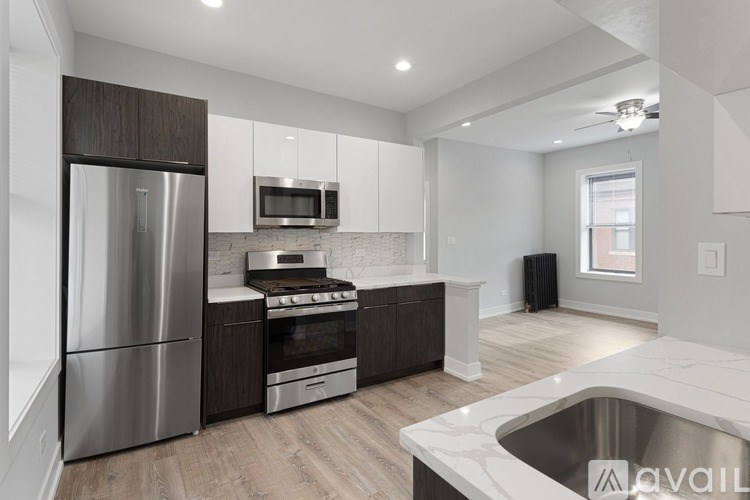 A modern kitchen with stainless steel appliances and wooden cabinets.