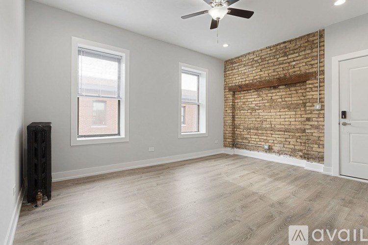 A room with a brick wall and a ceiling fan.